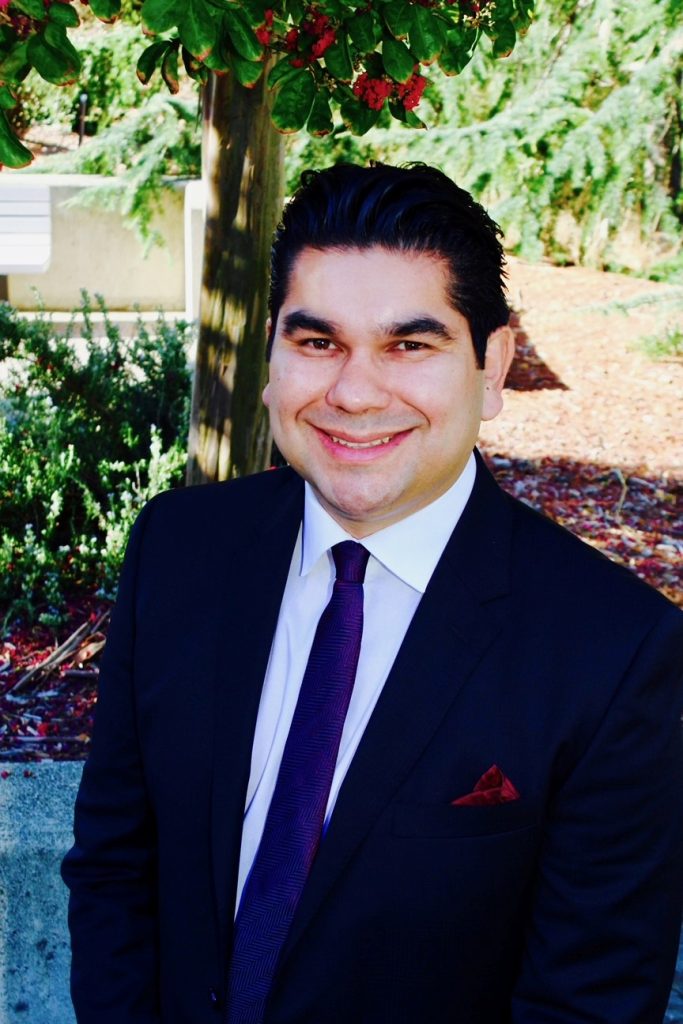 Dr. Cabral in a dark suit
